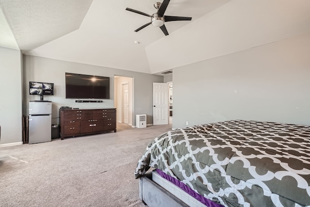 bedroom with a textured ceiling, ceiling fan, light carpet, lofted ceiling, and stainless steel refrigerator