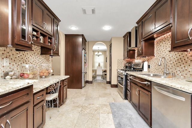 kitchen featuring appliances with stainless steel finishes, dark brown cabinetry, and tasteful backsplash