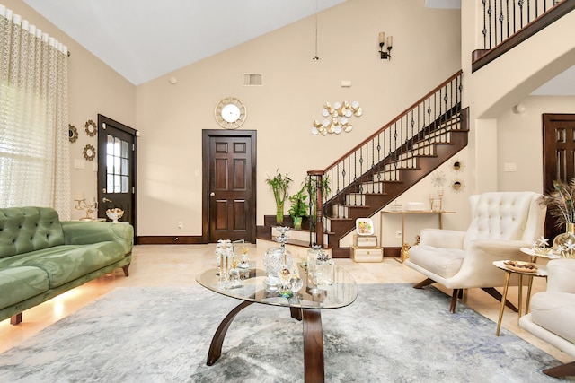 living room featuring an inviting chandelier and high vaulted ceiling