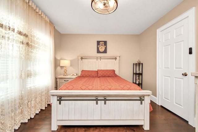 bedroom with dark wood-type flooring