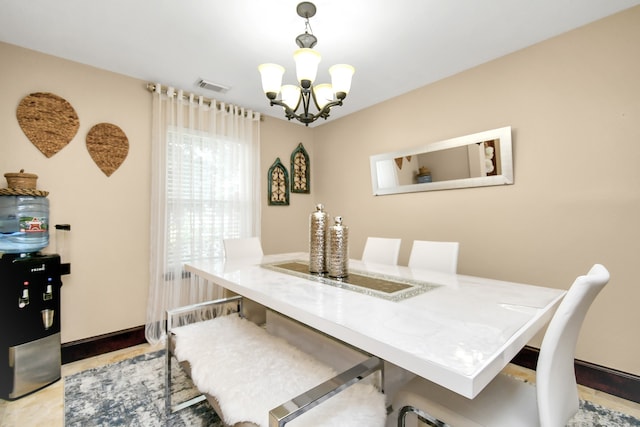 dining space featuring light hardwood / wood-style flooring and a chandelier