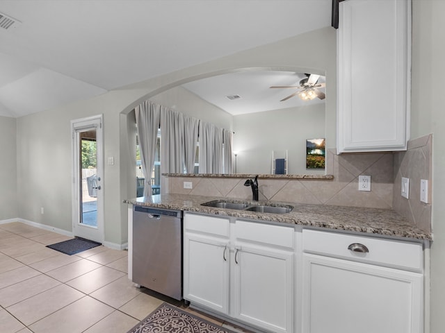 kitchen featuring decorative backsplash, white cabinetry, light stone countertops, stainless steel dishwasher, and sink