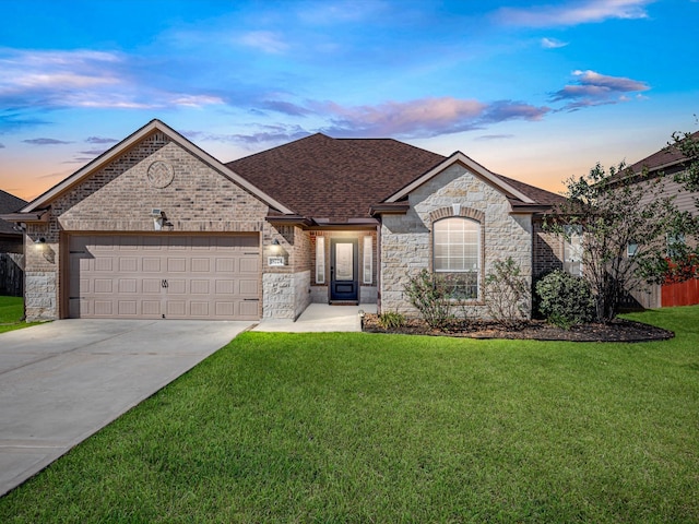 view of front of house with a yard and a garage