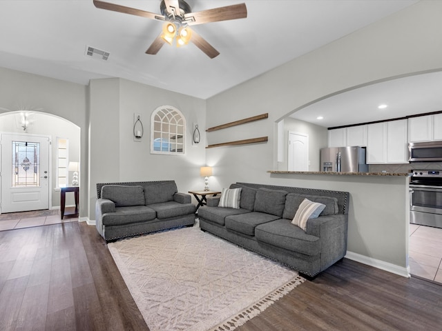 living room featuring hardwood / wood-style flooring and ceiling fan