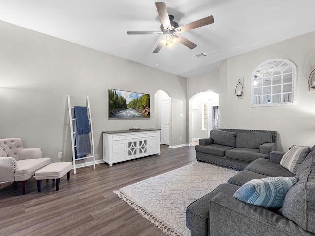 living room with ceiling fan and dark hardwood / wood-style flooring