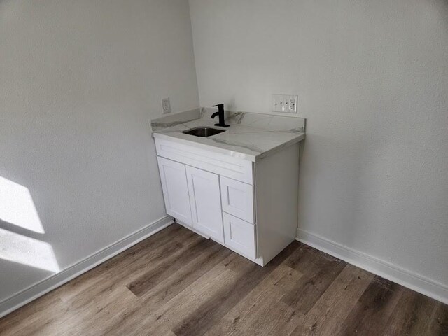 1202 3rd Ave N, Texas City, TX 77590 - washroom with dark wood-style flooring, baseboards, and a sink