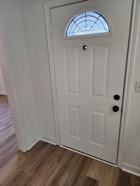 1202 3rd Ave N, Texas City, TX 77590 - entryway featuring dark wood-style flooring and baseboards