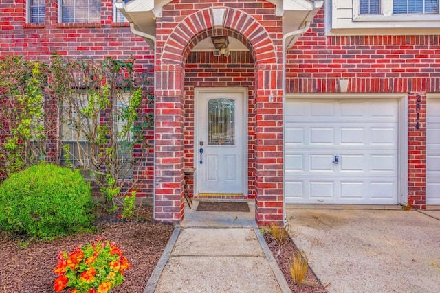 doorway to property with a garage