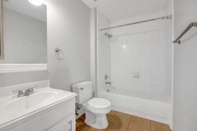 full bathroom with tile patterned floors, vanity, toilet, and tiled shower / bath combo