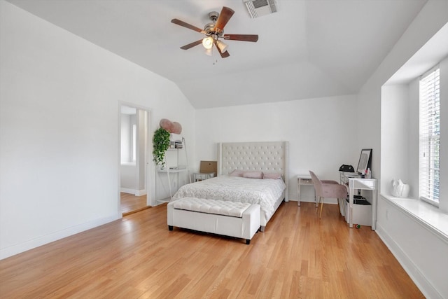 bedroom featuring ceiling fan, lofted ceiling, and light wood-type flooring