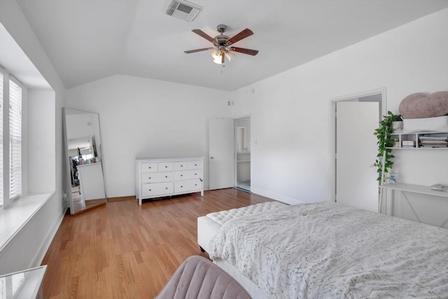 bedroom with ceiling fan, lofted ceiling, and light wood-type flooring