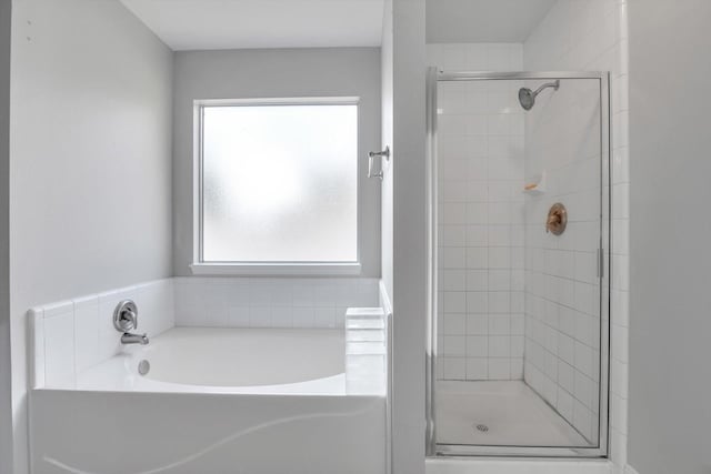 bathroom featuring separate shower and tub