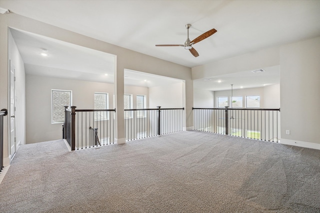 carpeted spare room with ceiling fan