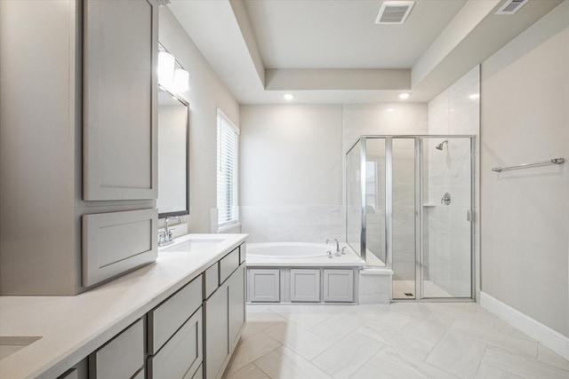 bathroom with vanity and separate shower and tub