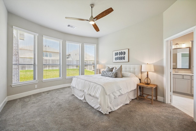 carpeted bedroom with sink, connected bathroom, and ceiling fan