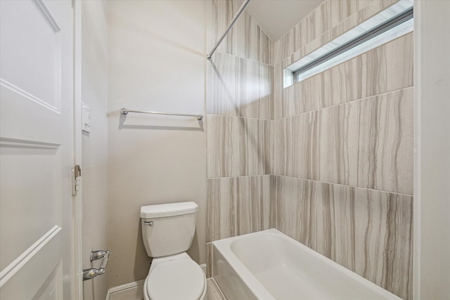 bathroom featuring toilet and tiled shower / bath combo