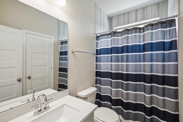 bathroom featuring toilet and vanity