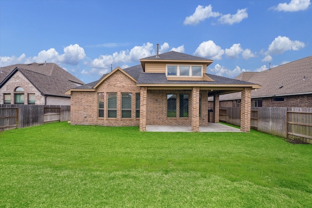 rear view of house with a patio area and a yard