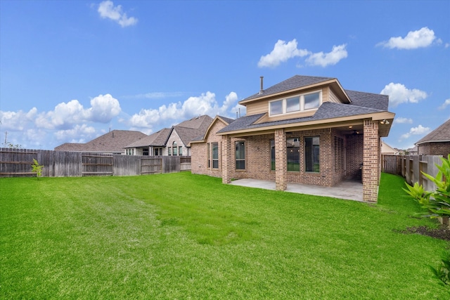 back of house featuring a yard and a patio area