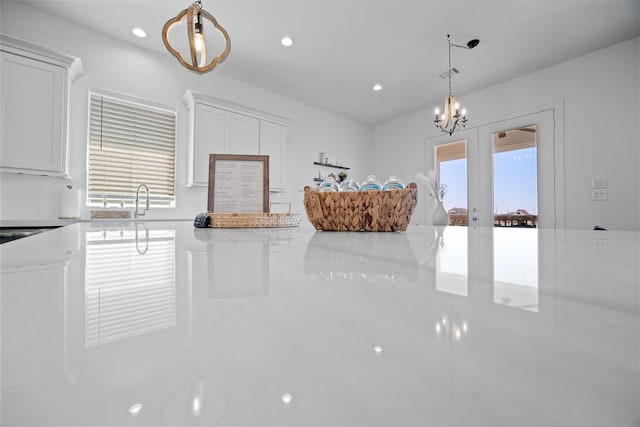 22831 Cuadro St, Galveston, TX 77554 - kitchen with light countertops, white cabinetry, decorative light fixtures, a chandelier, and recessed lighting