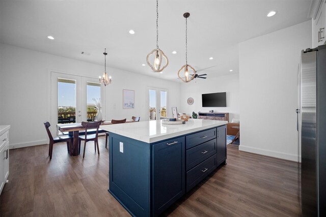 22831 Cuadro St, Galveston, TX 77554 - kitchen featuring a chandelier, blue cabinets, freestanding refrigerator, healthy amount of natural light, and recessed lighting