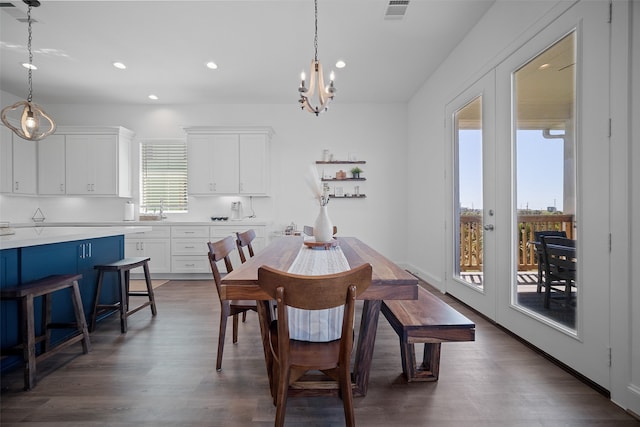 dining space featuring sink, dark wood-type flooring, french doors, and plenty of natural light