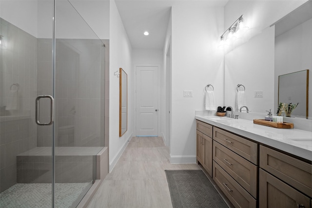 22831 Cuadro St, Galveston, TX 77554 - bathroom with a shower stall, double vanity, baseboards, and recessed lighting