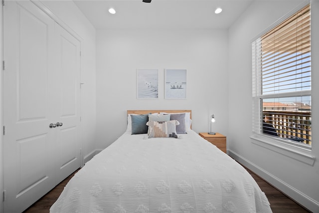 bedroom featuring dark hardwood / wood-style floors and a closet