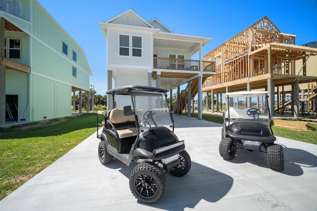 22831 Cuadro St, Galveston, TX 77554 - view of patio featuring driveway, a carport, and stairs