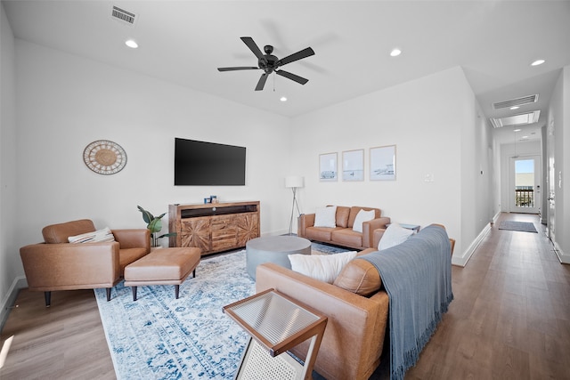 living room featuring light hardwood / wood-style floors and ceiling fan