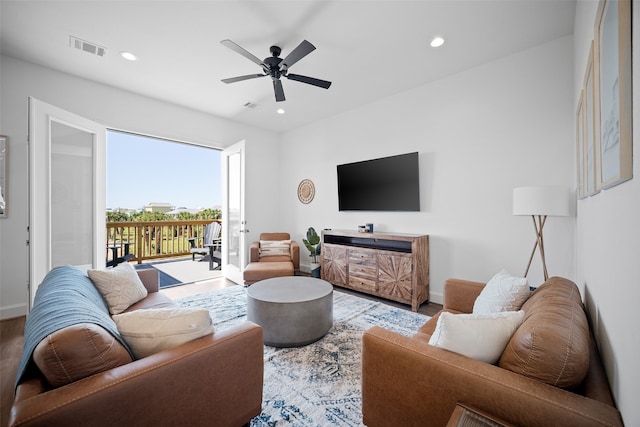 living room with wood-type flooring and ceiling fan