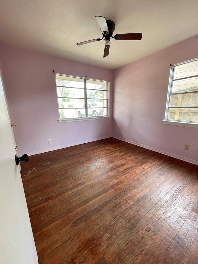 empty room featuring dark hardwood / wood-style flooring and ceiling fan