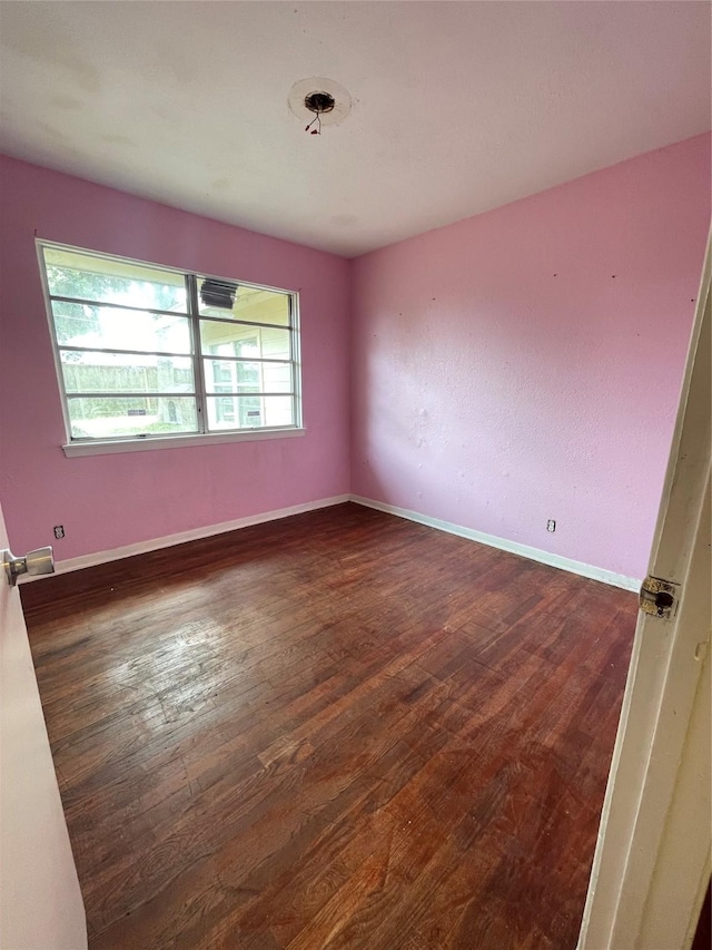 empty room with dark wood-type flooring