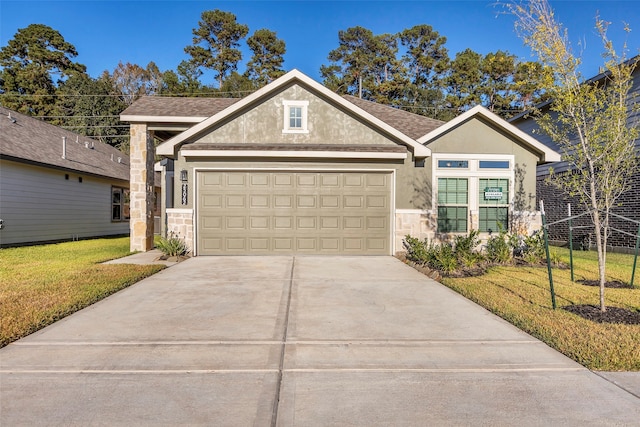 view of front of property with a front lawn and a garage