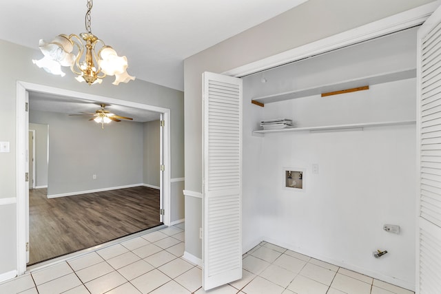 washroom with hookup for a washing machine, light hardwood / wood-style floors, and ceiling fan with notable chandelier