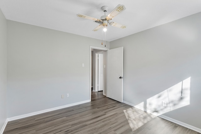 spare room featuring dark hardwood / wood-style floors and ceiling fan