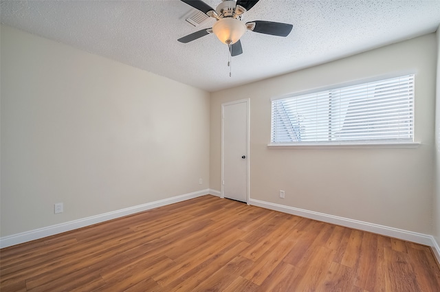 spare room with light hardwood / wood-style flooring, a textured ceiling, and ceiling fan