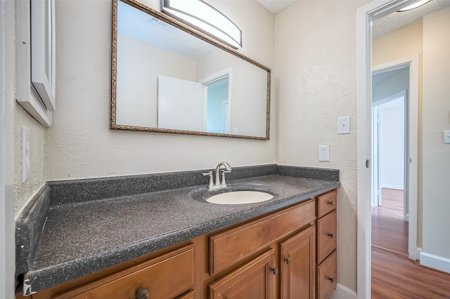 bathroom with vanity and hardwood / wood-style flooring