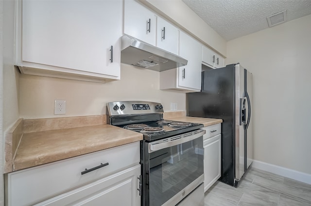 kitchen with appliances with stainless steel finishes, a textured ceiling, and white cabinetry