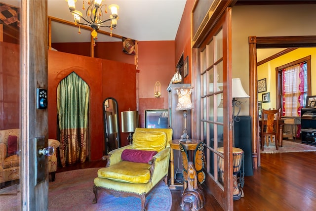 living area with a notable chandelier and wood finished floors