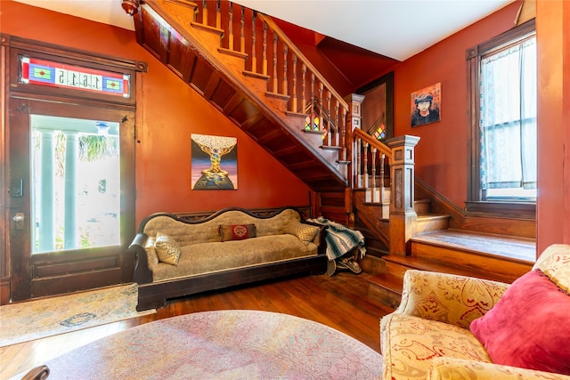 living room with wood-type flooring and stairs
