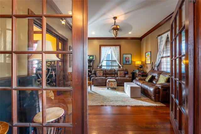 living room featuring ornamental molding and dark hardwood / wood-style floors