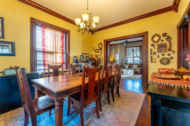 dining room featuring crown molding, dark hardwood / wood-style flooring, and a chandelier