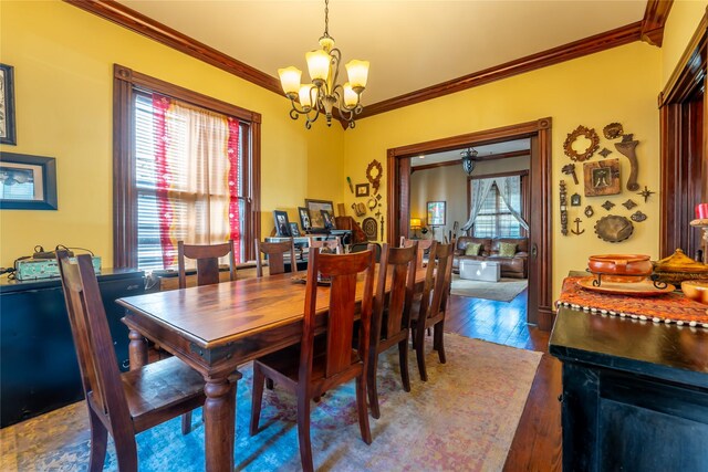 dining area featuring ornamental molding, a chandelier, and dark wood-style floors
