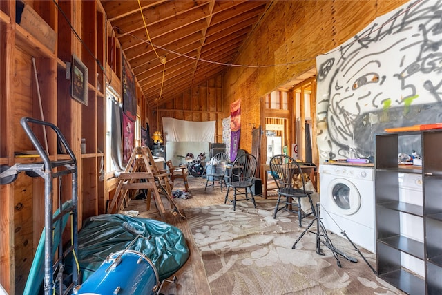 miscellaneous room featuring high vaulted ceiling, wood walls, and washer / clothes dryer