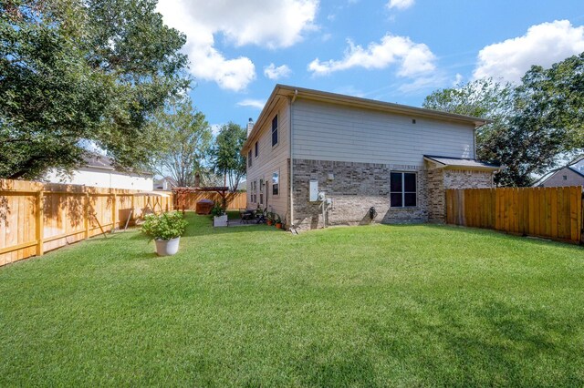 4609 Buescher Ct, Pearland, TX 77584 - rear view of house featuring a yard and a fenced backyard
