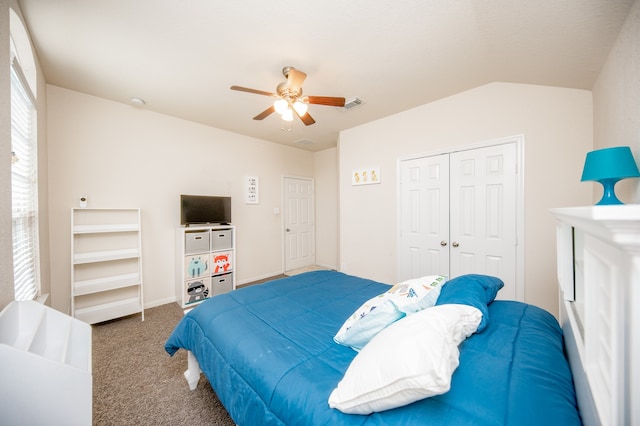 bedroom with a closet, carpet floors, vaulted ceiling, and ceiling fan