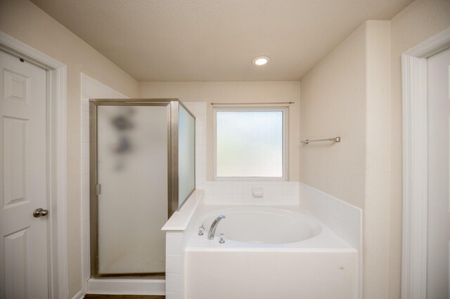 4609 Buescher Ct, Pearland, TX 77584 - bathroom featuring a bath, recessed lighting, and a shower stall