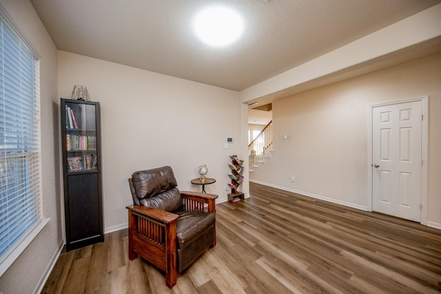 4609 Buescher Ct, Pearland, TX 77584 - living area with plenty of natural light, stairway, wood finished floors, and baseboards