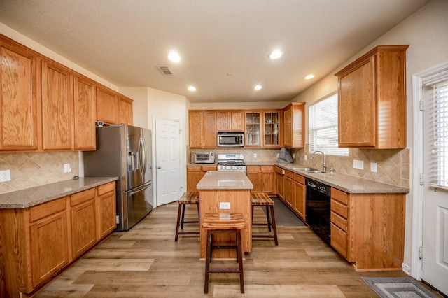 4609 Buescher Ct, Pearland, TX 77584 - kitchen featuring tasteful backsplash, stainless steel appliances, a kitchen breakfast bar, and a sink